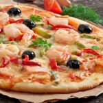 Fritti Di Mare, a delicious Italian fried seafood platter with shrimp, calamari, and other seafood, served with a side of marinara sauce.