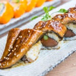 Dragon Roll with eel, avocado, cucumber, and spicy mayo, topped with eel sauce, served at Banjara at Manekchowk, Ashburn, VA.